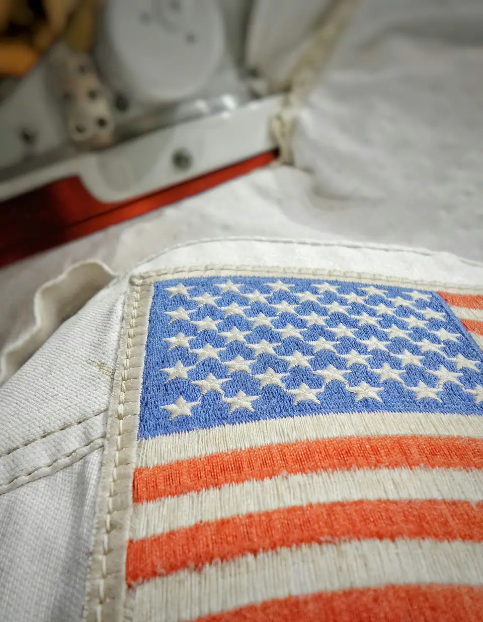 Close-up of embroidered white stars on the blue canton of an American flag