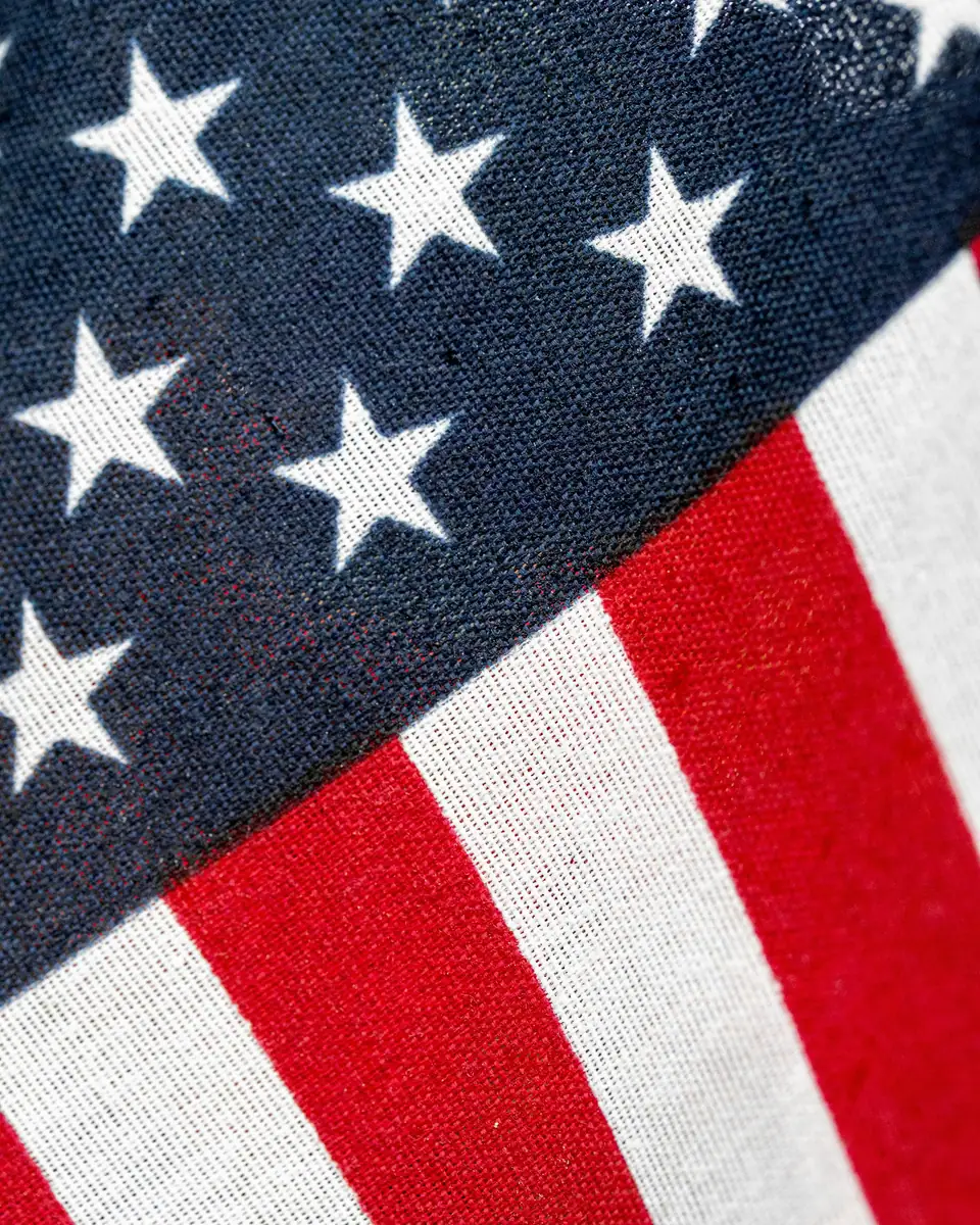 Close-up of American flag fabric showing white stars and red and white stripes