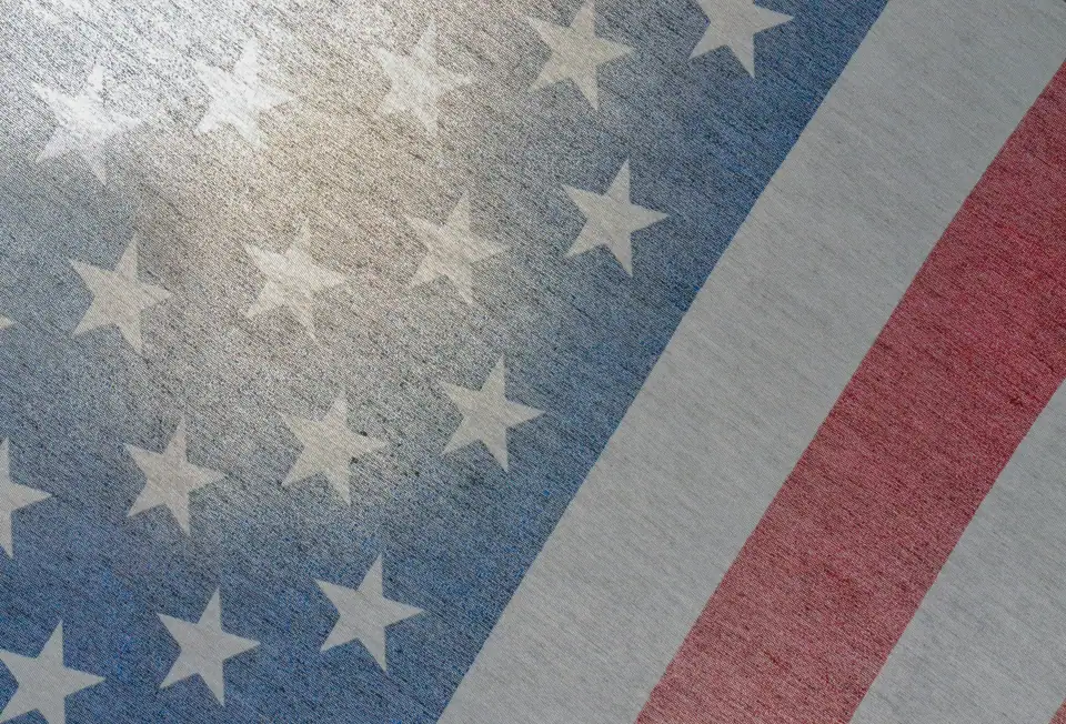 Close-up of American flag stars and red stripes on a diagonal